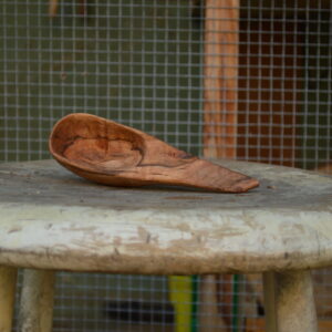 A rough-finished, hand-carved coffee scoop crafted from reclaimed Bay Area maple wood and finished with food-safe oil