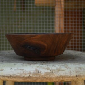 A side view of a decorative bowl made from reclaimed California walnut